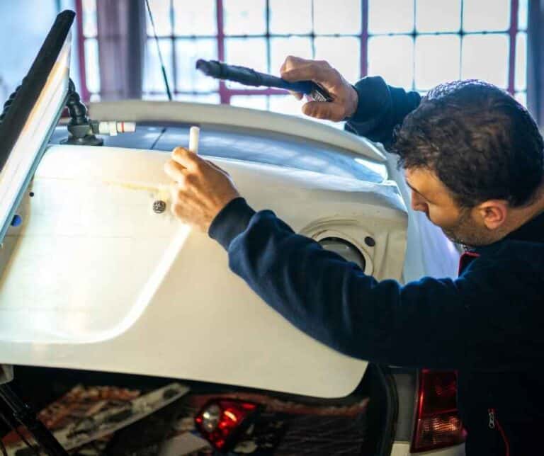 a person denting at the car door