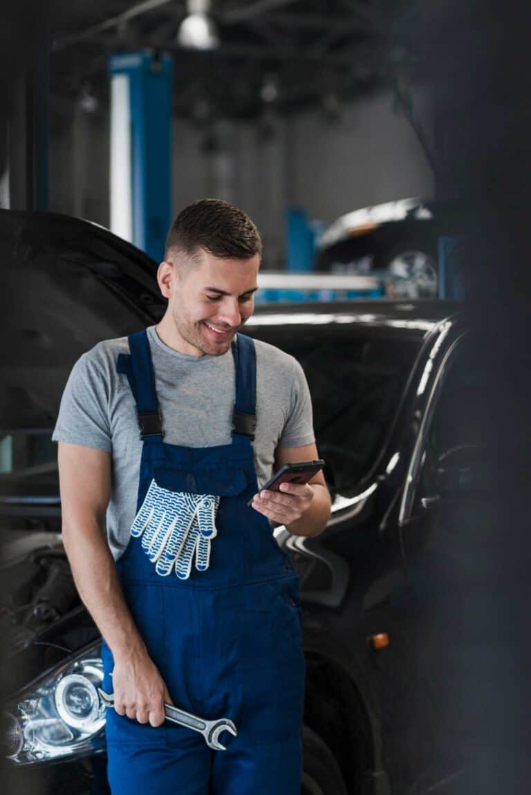 a mechanic holding his phone
